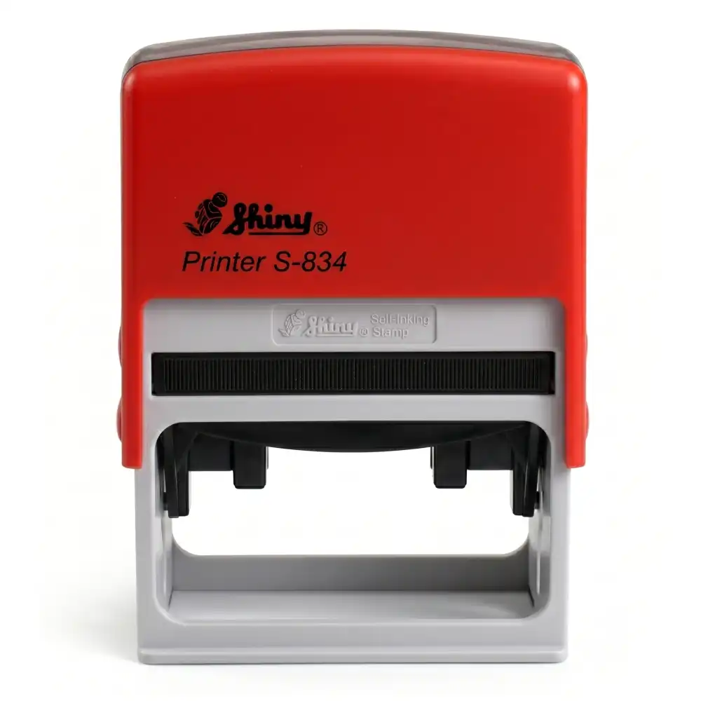 Shiny S-834 - 65x30 mm. | Sello Automático Rectangular 2 Vista frontal del sello automático Shiny Printer S-834 de 65×30 mm con carcasa roja y visor transparente